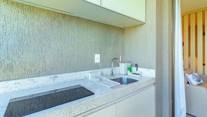 A kitchen with a granite countertop, stainless steel sink, and a built-in oven. - Beach Class Summer #303 Ipojuca By Carpediem (Ipojuca)