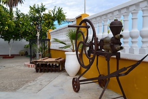 A vintage mechanical device, possibly a water pump, next to a white wall with a yellow baseboard. - Moriles Traditional Farmhouse for 8 (Moriles)