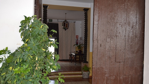 A doorway leading to a room with a tiled floor and a small potted plant. - Moriles Traditional Farmhouse for 8 (Moriles)