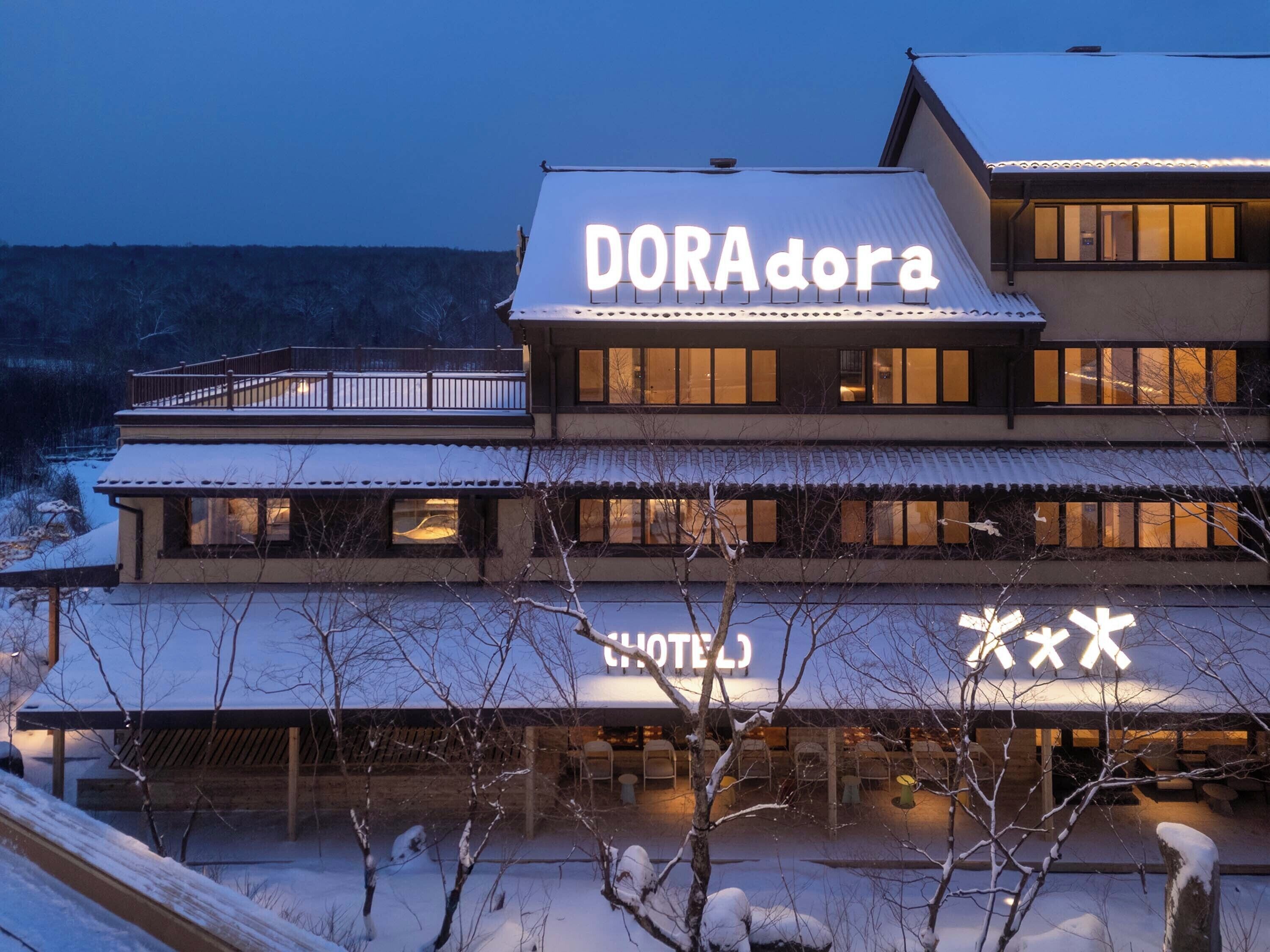 A hotel with a sign reading "DORAdora HOTEL".