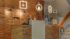 Ein Empfangsbereich mit modernem Design, inklusive einer Wand mit Muster und einer Rezeption.