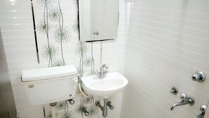 A small bathroom with a toilet, sink, and bathtub.