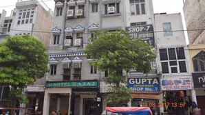 A multi-story building with a prominent sign for 'Hotel Bajaj' at the ground level.