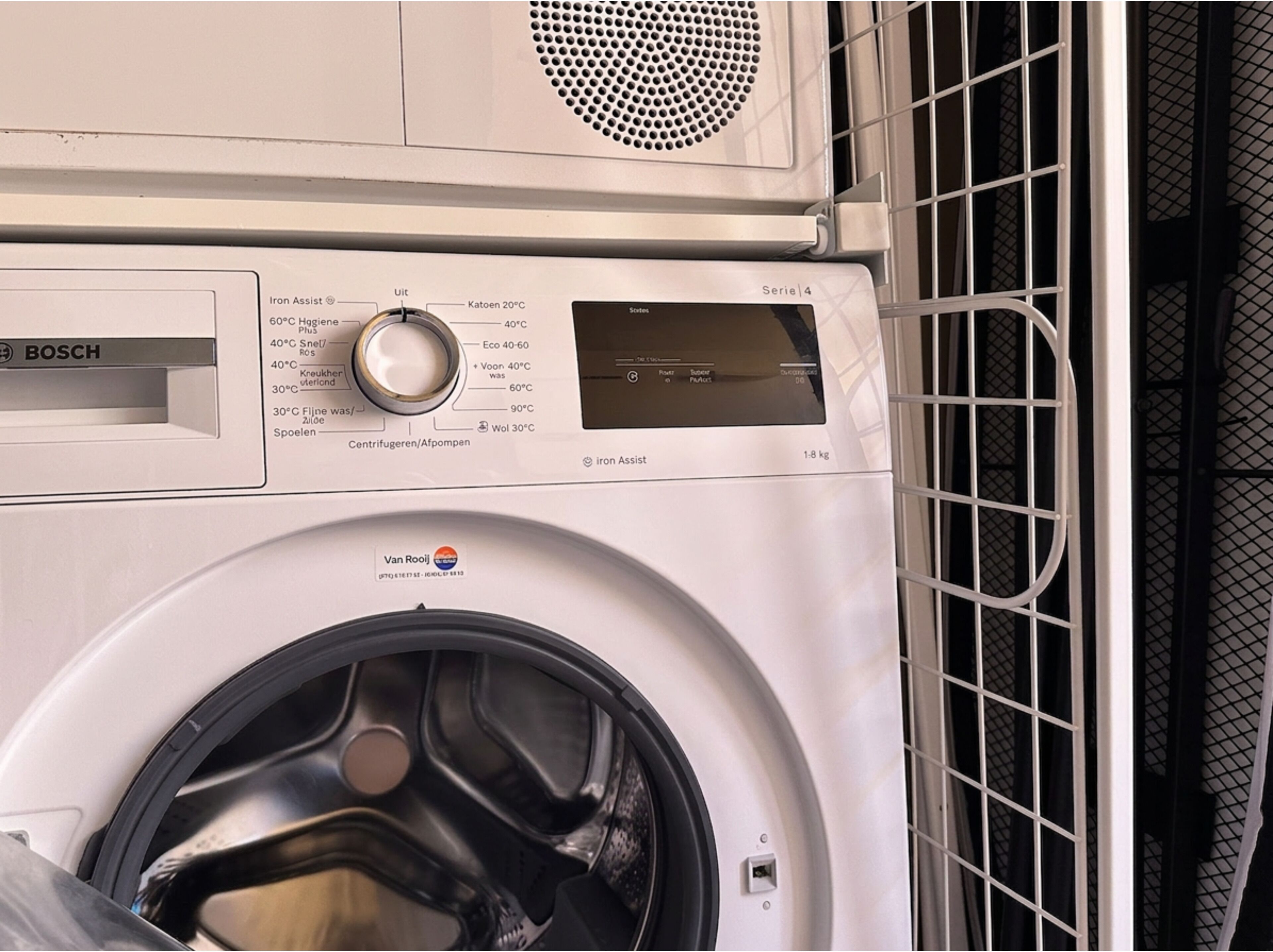 Una lavadora Bosch con panel de control y conducto de ventilación.