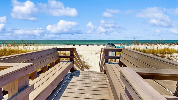 A wooden boardwalk leading to a beach with a clear sky. - Beautiful beachfront condo with million-dollar views with Seasonal Beach Service and Beach Access (Fort Walton Beach)