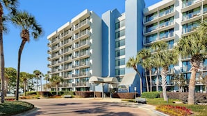 A modern hotel with multiple balconies, a covered entrance, and landscaped gardens. - Bayside Studio with nearby outlet shopping, Golf course and Community pool (Miramar Beach)
