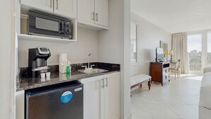 A compact hotel kitchen with a microwave, coffee maker, and sink. - Bayside Studio with nearby outlet shopping, Golf course and Community pool (Miramar Beach)
