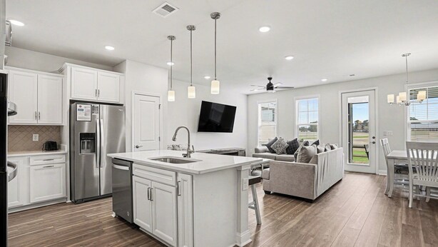 A modern kitchen with white cabinetry, stainless steel appliances, and pendant lighting. - The Townes #5145: Gorgeous New 4BR in Barefoot! With Driving Range Views! (North Myrtle Beach)