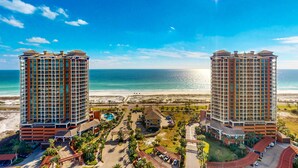 Two high-rise buildings with a beach and ocean view. - Gorgeous Resort Condo with Gulf Views, Shared Hot Tub, Pools, & Gym (Pensacola Beach)