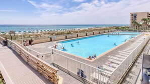 A swimming pool with a view of the beach and ocean. - Beautiful beachfront home with shared pool and beach access (Fort Walton Beach)