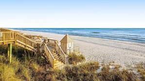 A wooden staircase leading to a beach area with a lifeguard tower. - Fifth-floor, oceanfront condo with fast WiFi & pool  -  snowbirds OK (Miramar Beach)