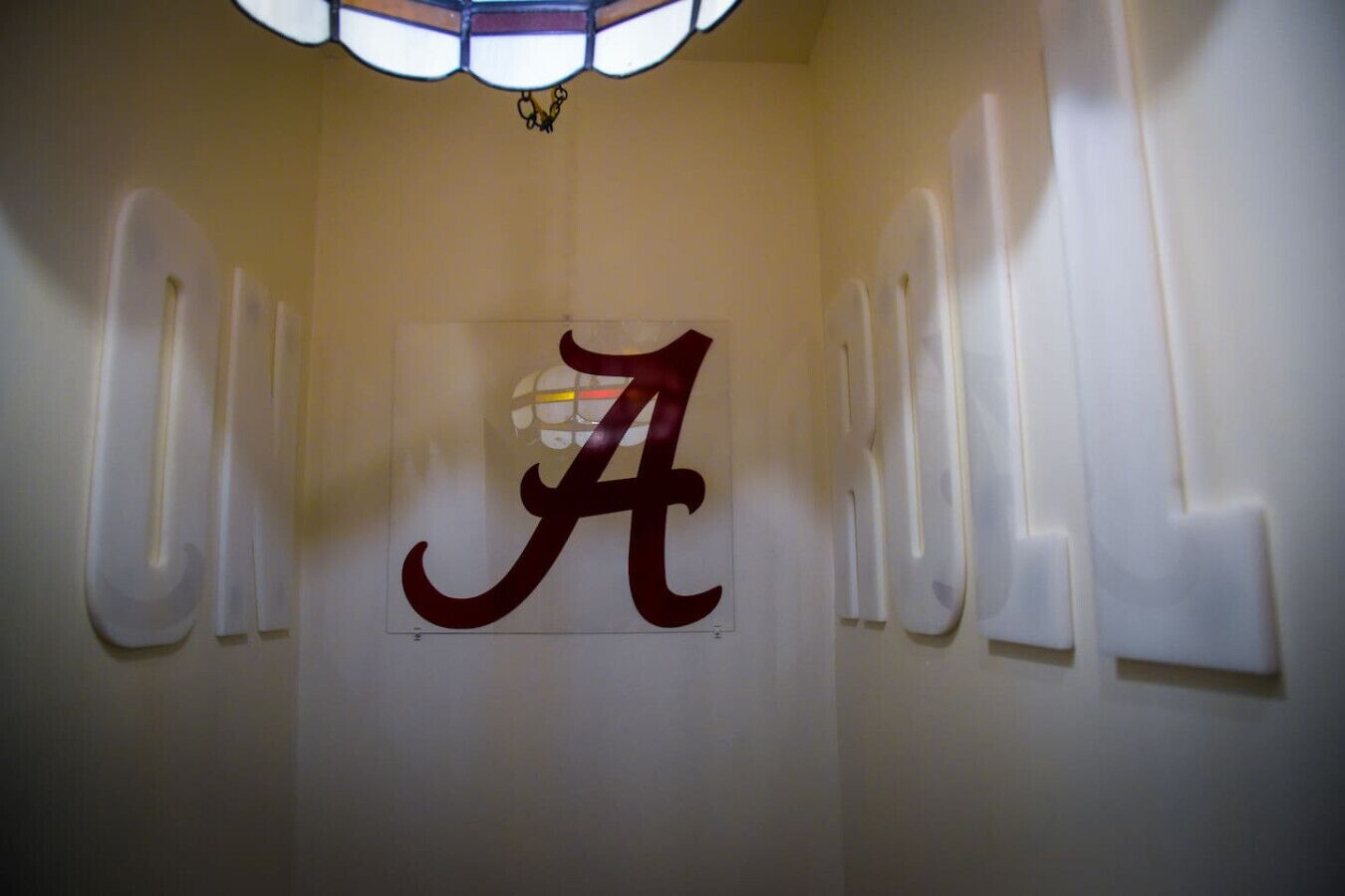 A wall with a large, stylized 'A' logo, likely representing a brand or location.