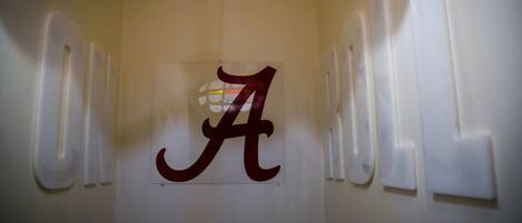 A wall with a large, stylized 'A' logo, likely representing a brand or location.