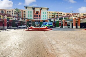 A hotel with a central courtyard, multiple balconies, and a ReStore sign. - Gulf Front 4BR w Balcony, Pool, Hot Tub & W&D (Fort Walton Beach)