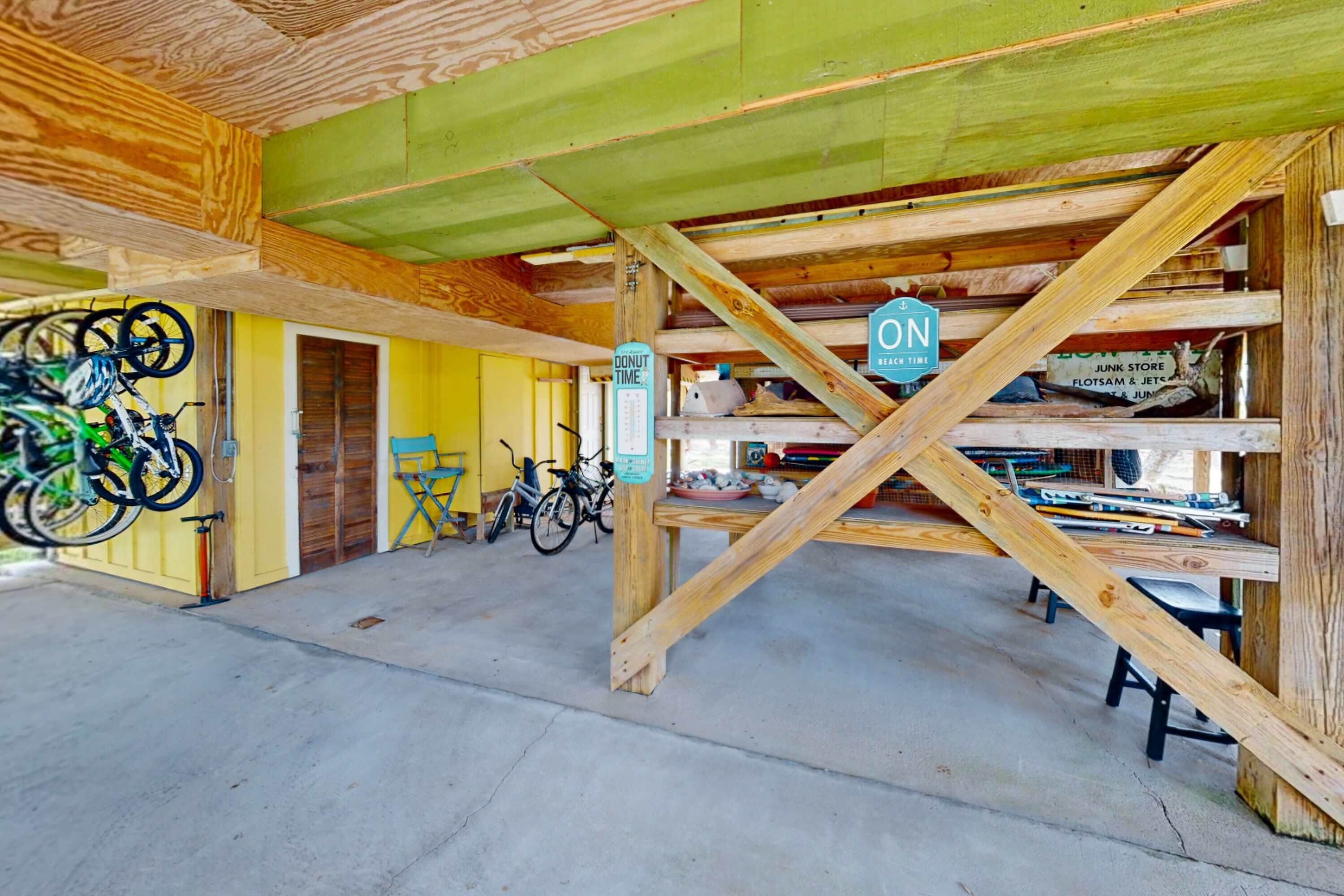 A wooden interior with a sloped ceiling, bicycles, and a sign indicating a donut shop.