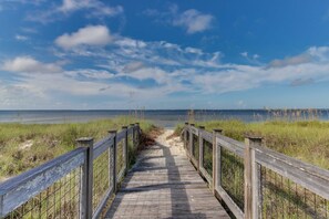 A wooden boardwalk leading to a beach with a clear sky. - Beachy retreat within easy walking distance to pool, beach access & restaurants (Port St. Joe)