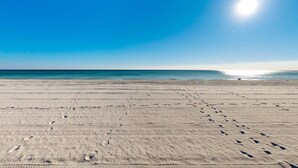 A beach with footprints and a clear sky. - Gulf Front 4BR | Pools | Hot Tub | Balcony | W/D (Fort Walton Beach)
