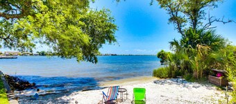Inviting bayfront suite with water views, picnic area & pool