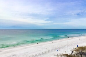 A wide beach with a clear sky and calm sea. - Gulf-front condo with views, beach access, pool, balcony, & fitness room (Fort Walton Beach)