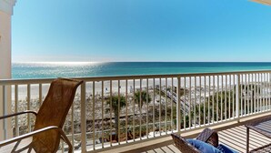 Ein Balkon mit Blick auf Strand und Meer.
