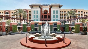 A hotel with a central fountain, multiple balconies, and a symmetrical facade. - 4th-Floor Azure Condo with Free WiFi, Beach Service, Gulf View, Shared Pool,Hot Tub (Fort Walton Beach)