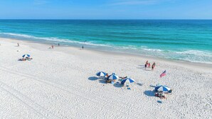A beach with white sand, clear blue water, and people sunbathing. - Second-floor, airy condo with great views - close to dining & shopping (Fort Walton Beach)