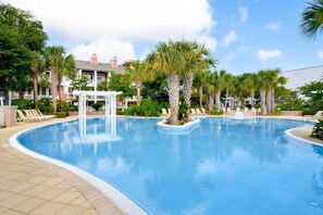 A swimming pool with lounge chairs and palm trees. - Ground-floor condo with patio, central AC, shared pool & tennis (Miramar Beach)