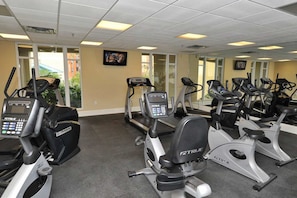 A gym with multiple cardio machines, including treadmills and stationary bikes, arranged in rows. - Beautiful coastal retreat with water view, beach access, & shared pool,hot tub (Fort Walton Beach)