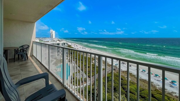 A balcony with a view of a beach and ocean. - Beach front condo with washer&dryer, shared pool and beach access (Santa Rosa Beach)