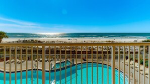 A pool area with a view of the beach and ocean. - Pretty Gulf Front Condo Fun Amenities, Nearby Shopping & Dining! (Fort Walton Beach)