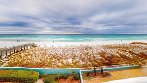 A beach with a wooden boardwalk, sandy dunes, and a view of the ocean. - Beautiful beachfront condo with shared pool & beach access! (Fort Walton Beach)