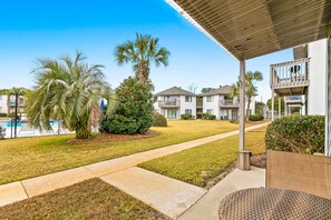 A residential area with a pool, palm trees, and a covered patio. - Ground Floor Condo with Onsite Pool View & Access, Patio, Central AC, & WiFi (Miramar Beach)