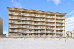 A multi-story hotel with balconies, located on a sandy beach. - Second floor oceanfront condo w ocean view, washer&dryer, AC, and pool access (Fort Walton Beach)