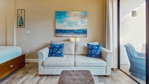 A bedroom with a bed, a sofa, and a window. - Comfy studio suite with pool & picnic area - snowbird-friendly (Fort Walton Beach)