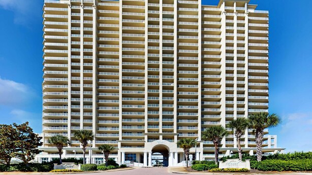 A multi-story hotel with a symmetrical facade, large windows, and a central entrance.