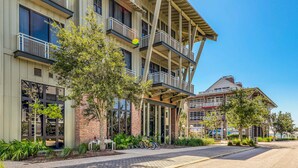 A multi-story building with balconies, large windows, and a brick facade. - Lovely coastal home with pool access, fast WiFi, screened patio & great location (Port St. Joe)