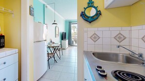 Uma cozinha com pia, fogão e área de jantar com mesa e cadeiras.