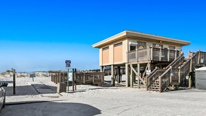 A beachside lifeguard tower with wooden stairs and a wheelchair-accessible ramp. - Second-story waterfront condo with pool view, W/D, AC - perfect location (Pensacola Beach)