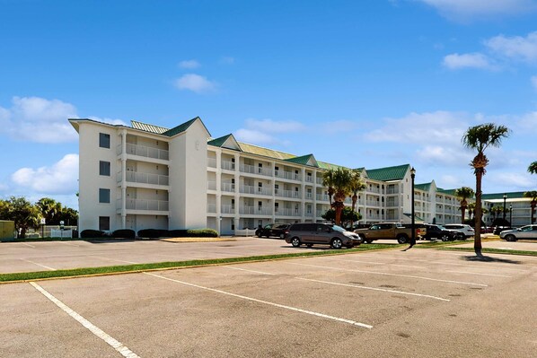 A multi-story hotel with a parking lot in front. - Beach haven at Maravilla Resort with 2 pools & tennis (Miramar Beach)