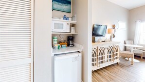 A compact kitchenette with a microwave, coffee maker, and storage shelves. - Cozy Hotel-Style- near beach & dining with kitchenette, pools, hot tub, & tennis (Santa Rosa Beach)
