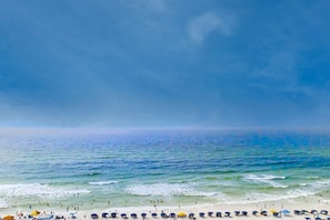 A beach with people and umbrellas. - Majestic Sun A806 Beachfront Views & Pool Fun! (Miramar Beach)