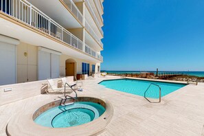 A hotel with a pool area, a hot tub, and a view of the ocean. - 9th Floor Gulf-Front Condo with Plenty Of Resort Amenities, Close To Dining (Navarre Beach)
