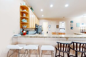 Fridge, microwave, oven, stovetop - Dog-friendly home with balconies, foosball, pool access, & W&D - steps to beach (Panama City Beach)