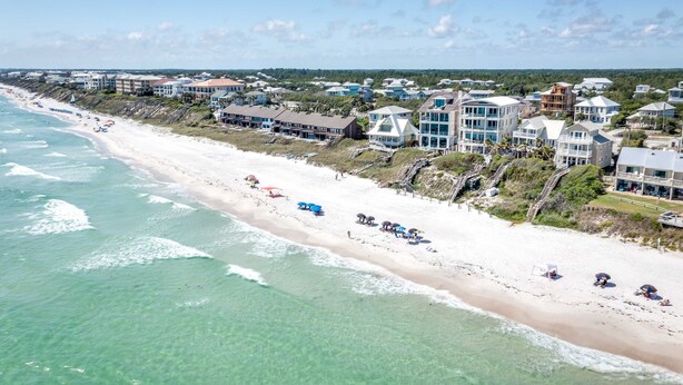 A coastal hotel with beachfront rooms, a sandy beach, and ocean views.