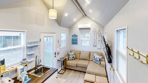 A compact living space with a kitchenette, a sofa, and a dining area. - Peaceful & sun-soaked getaway with fire pit & W&D - near beaches, trails, & golf (Navarre)