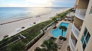 A beachfront hotel with a pool, beach access, and a pier in the background. - 16th-floor condo with Gulf views, beach access, 2 pools, hot tub, & private W&D (Panama City Beach)