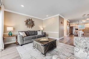 A living room with a gray sofa, a coffee table, and a patterned rug. - The Salty Seahorse at Sea Bluff | Pool, Private Beach Access | Walk to Dining (Santa Rosa Beach)