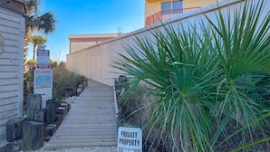 A private property with a wooden boardwalk leading to a building. - Gorgeous home with private pool, outdoor space and close to beach (Panama City Beach)