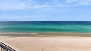 A beach with a clear sky and calm sea. - Stylish oceanfront condo including shared pool and beach access (Panama City Beach)
