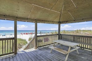A wooden deck with a picnic table and a beach view. - Beach Condo with Free WiFi, Washer/Dryer, Beach Service Now Included (Miramar Beach)